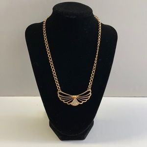 Gold tone wing design necklace